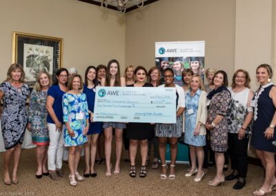 Group young ladies smiling with their awarded scholarship certificates from 2018