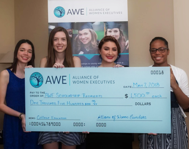 Group young ladies smiling with their awarded scholarship certificates from 2018