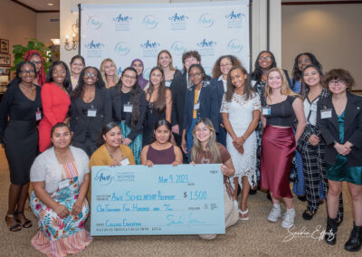Group young ladies smiling with their awarded scholarship certificates from 2023